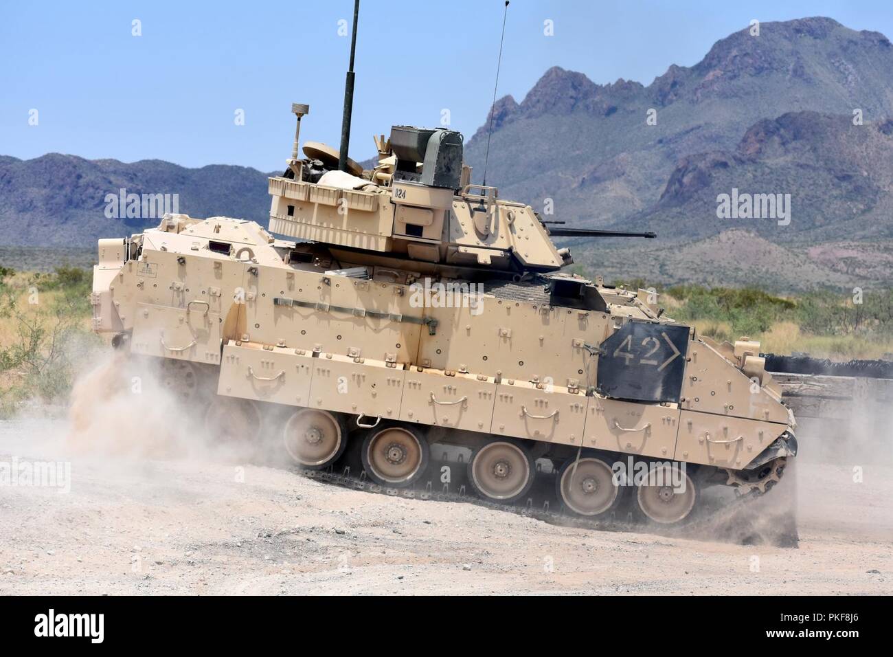 An M2A3 Bradley Fighting Vehicle crew changes position on the range