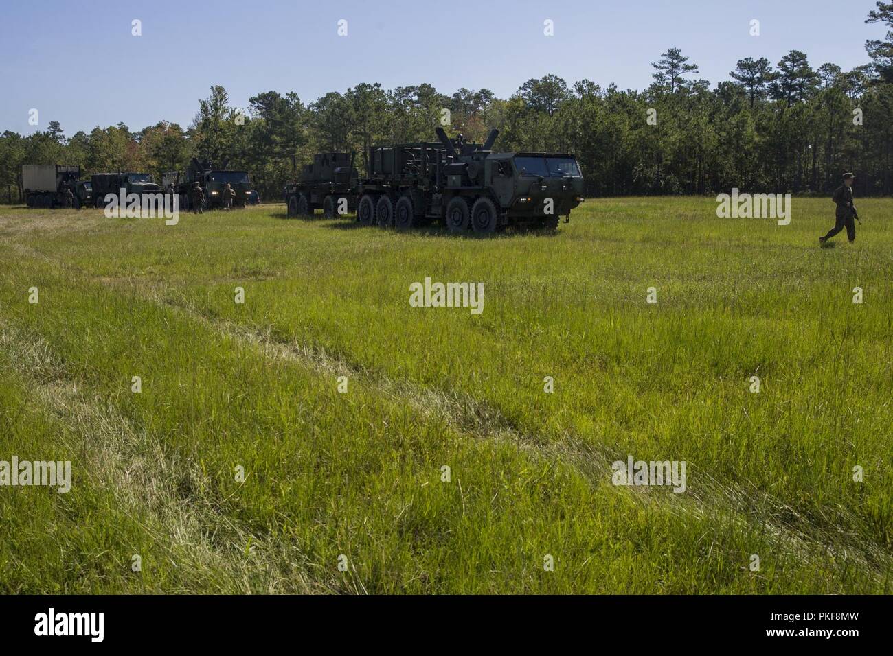 U.S. Marines with Combat Logistics Battalion 251, 2nd Marine Logistics Group, stage tactical vehicles for a reception, staging, onward movement and integration drill during a mission rehearsal exercise on Landing Zone Woodpecker, Camp Lejeune, N.C., Aug. 9, 2018. CLB-251 conducted the RSO&I drill in order to improve mission capability and warfighting readiness in ship-to-shore logistical operations that will be implemented in the NATO-led exercise Trident Juncture 18 later this year. Trident Juncture 18 is part of a planned exercise series to enhance the U.S. and NATO allies’ ability to work t Stock Photo