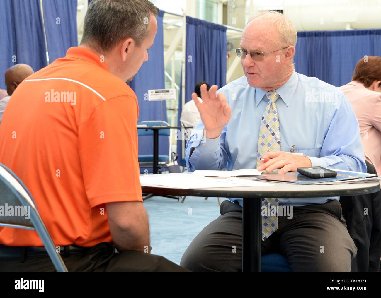 DIEGO (Aug. 7, 2018) Jim Reed, Space and Naval Warfare Systems Center Pacific Business Portfolio Manager for Transport Computing Infrastructure provides insights to industry representative during a matchmaking session at the 2018 National Defense Industrial Association (NDIA) Navy Gold Coast Conference. This year marks the 30th annual NDIA San Diego Chapter event. NDIA Navy Gold Coast Conference provides a forum to educate, guide and assist businesses, especially small businesses, in working with the government. Stock Photo