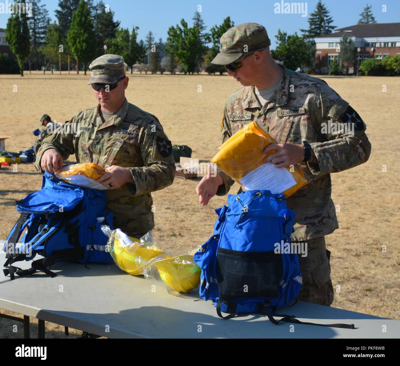Sgt. William Kreamer, an infantryman from 4th Battalion, 23rd Infantry, and Spc. Hunter Johnson a medic from 1st Battalion, 17th Infantry Regiment, are part of the 200 2nd Stryker Brigade Combat Team Soldiers from Joint Base Lewis-McChord drawing firefighting protective gear during the initial stages of preparation to support the National Interagency Fire Center in suppressing the wildfires in the Western United States, Aug. 9, 2018. Stock Photo