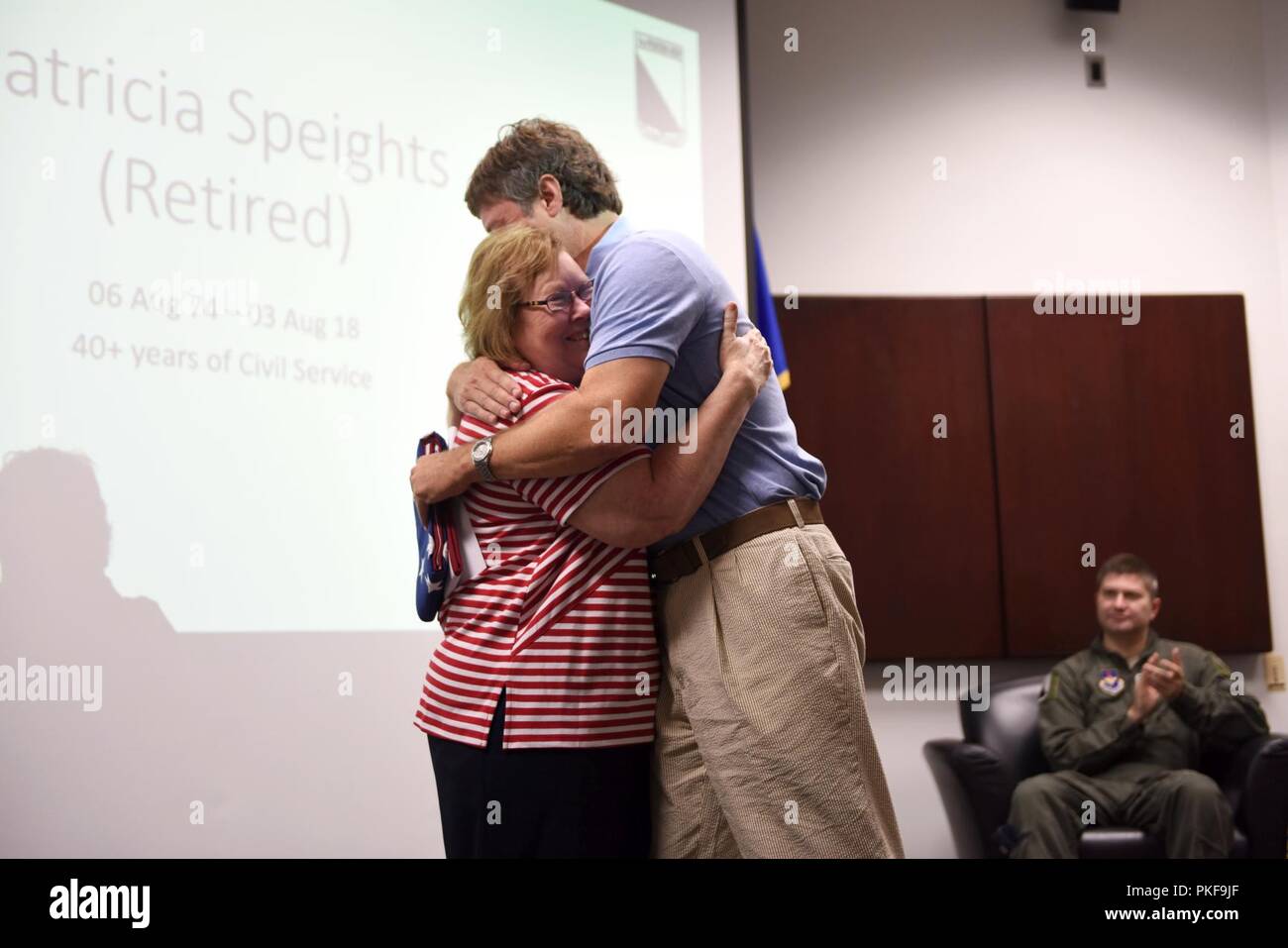 Patricia Speights, former 14th Operations Group secretary, hugs her son, Jamie, after presenting him with an American flag Aug. 3, 2018, on Columbus Air Force Base, Mississippi. Speights and her family served the Air Force for 40 years. Stock Photo