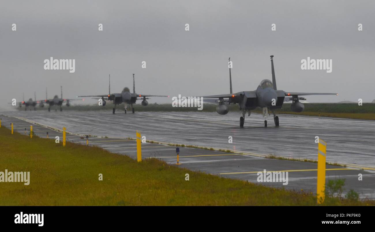 Four F-15C Eagle assigned to the 493rd Expeditionary Fighter Squadron taxi down the flightline after landing at Keflavik Air Base, Iceland, Aug. 3, 2018, in support of NATO’s Icelandic Air Surveillance mission. More than 250 U.S. Air Forces in Europe-Air Forces Africa Airmen and 14 F-15C/D Eagles deployed from Royal Air Force Lakenheath, England, with additional support from U.S. Airmen assigned to Aviano Air Base, Italy, Royal Air Force Mildenhall, England, and Ramstein Air Base, Germany. Stock Photo