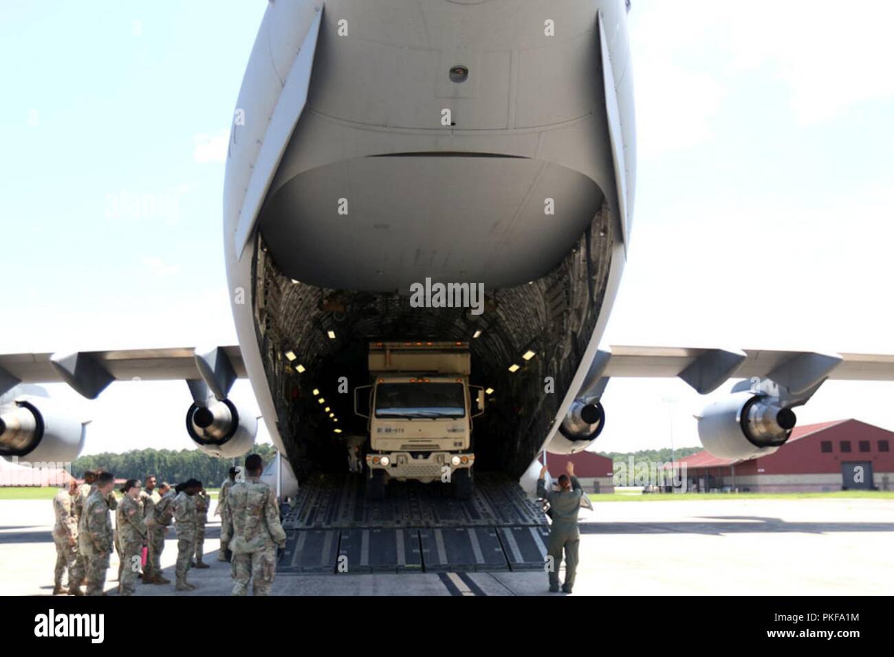 A Soldier loads a vehicle on a C17 during an Emergency Deployment