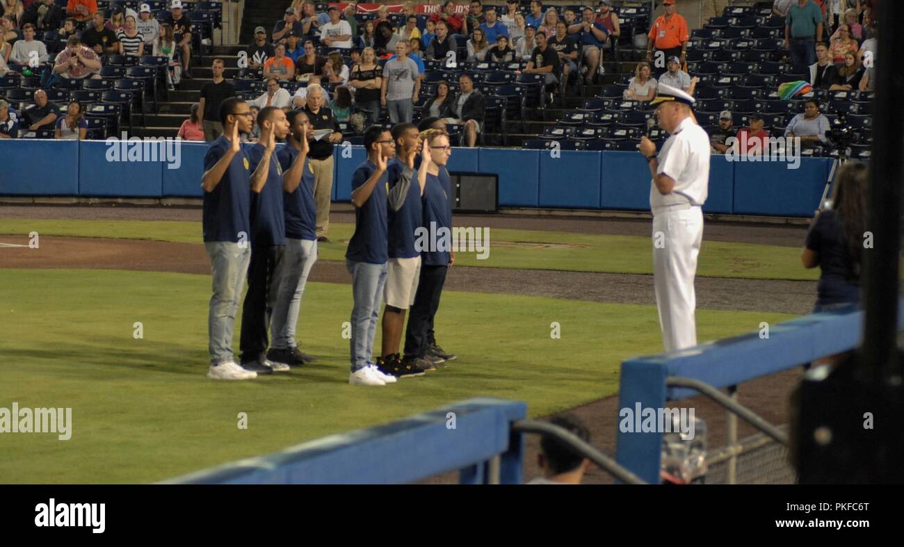 Rear Admiral Chip Rock, Commander, Navy Region MidAtlantic, administers the Oath of Enlistment