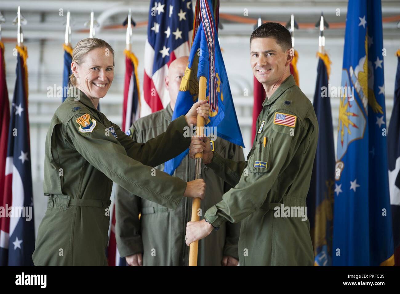 U.S. Air Force Col. Lisa Nemeth, 6th Operations Group commander, passes the 310th Airlift Squadron (AS) guidon to Lt. Col. Daniel Lindley during a change of command ceremony at MacDill Air Force Base, Fla., Aug. 3, 2018. Lt. Col. Carol Mitchell relinquished command to Lindley, who previously served as the assistant director of operations at the 310th AS. Stock Photo