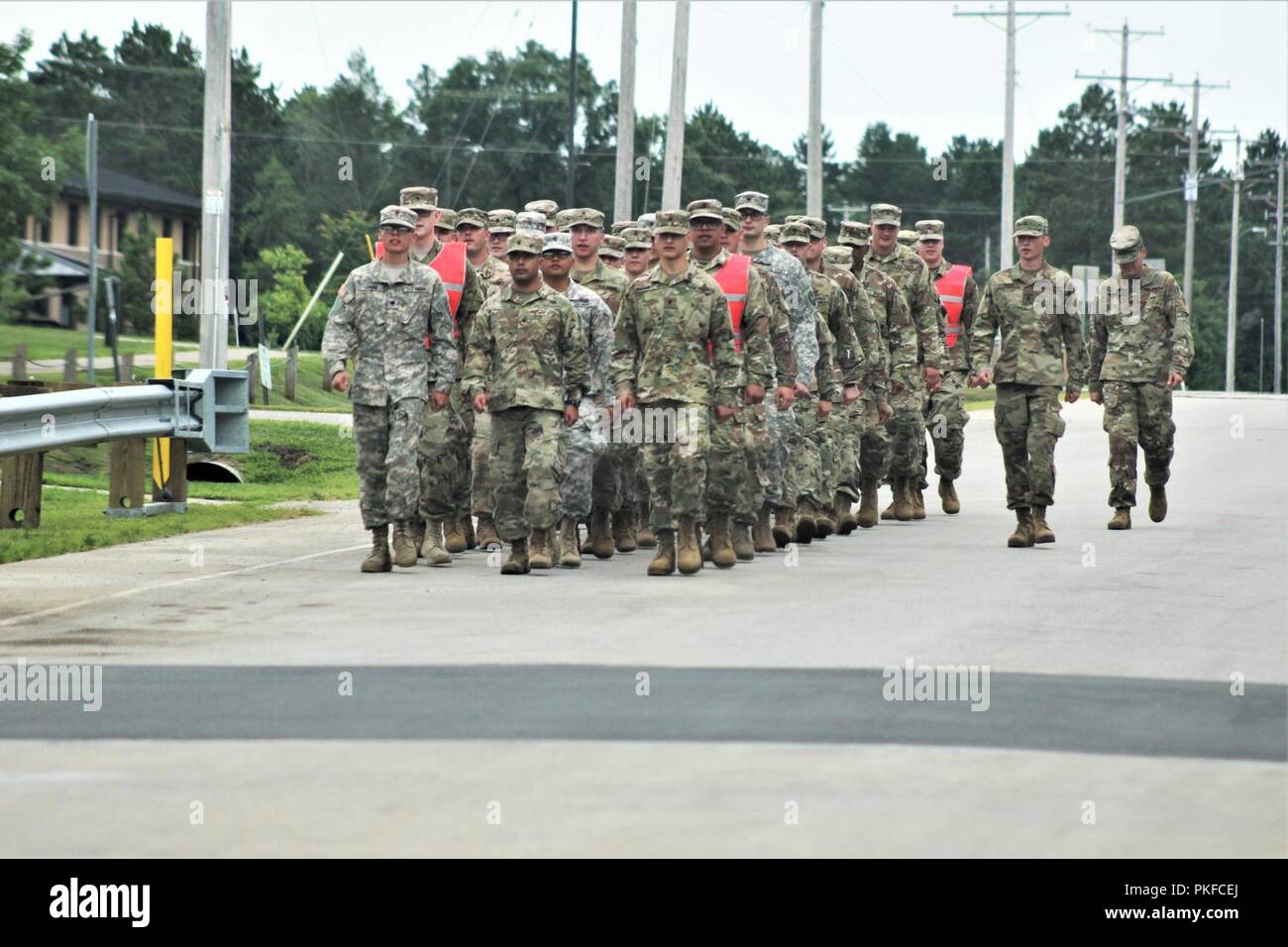 Students in the Fort McCoy Noncommissioned Officer Academy’s Basic Leader Course march along an installation roadway Aug. 3, 2018, at Fort McCoy, Wis. The students were returning to their campus after completing their lunch meal at the dining facility in building 50. The NCO Academy was activated at Fort McCoy in 1988. The academy is one of the largest tenant organizations at the installation providing institutional training with more than 1,800 students attending annually for the Battle Staff Noncommissioned Officer Course and BLC. Stock Photo