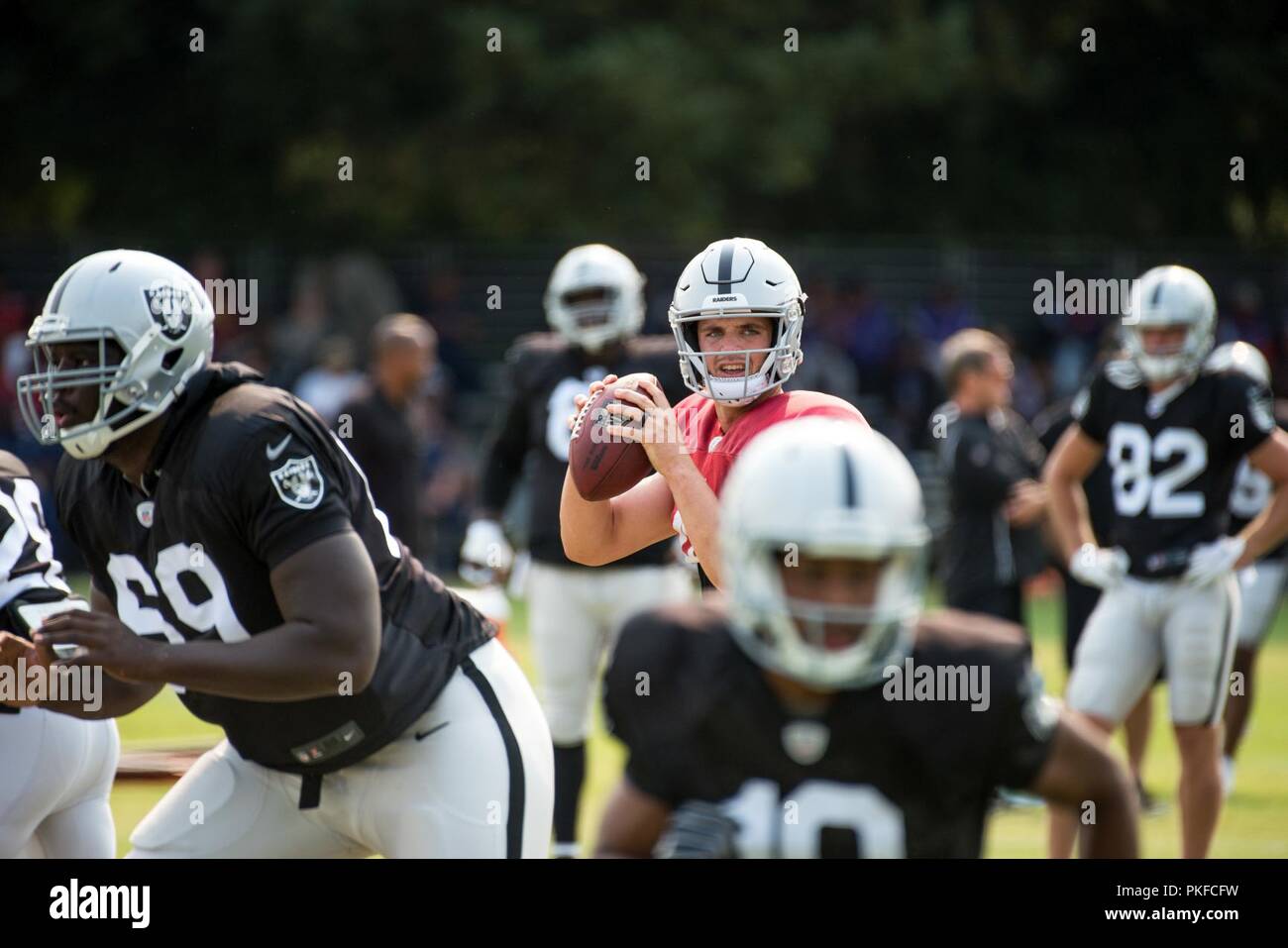 Oakland Raiders Quarterback Derek Carr throws a pass during practice at their training facility in Napa Valley, Calif., August 7, 2018. The Raiders invited Travis Air Force Base Airmen to attend camp and were treated to a scrimmage between the Raiders and Detroit Lions and a meet and greet autograph session with players and coaches from both teams. Stock Photo