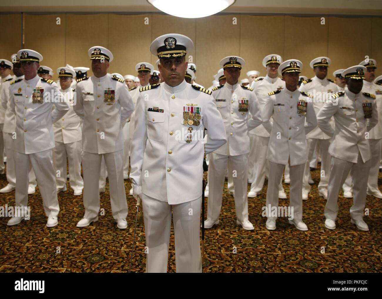 NORFOLK, Va. (Aug. 10, 2018) Led by USS Gerald R. Ford's (CVN 78) Reactor Officer Capt. Mattew Kawas, crew members assigned to Ford stand in formation during the ship's change of command ceremony at Vista Point onboard Naval Station Norfolk. The change of command ceremony is a time-honored Naval tradition in which the transfer of responsibility, authority, and accountability occurs from one individual to another individual. Stock Photo