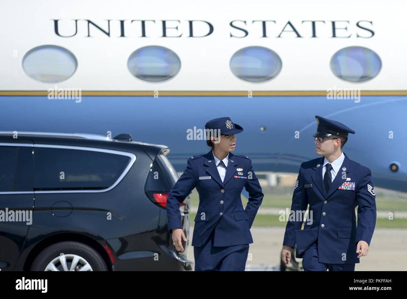(From left) 1st Lt. Kassandra Prusko and Staff Sgt. Joseph Shank depart the flight line after executing their duties as the official greeting party upon the arrival of a U.S. Official, Aug. 5, 2018 at Joint Base Andrews, Md. The 89th Airlift Wing provides global Special Air Mission airlift, logistics, aerial port and communications for the president, vice president, cabinet members, combatant commanders and other senior military and elected leaders as tasked by the White House, Air Force chief of staff and Air Mobility Command. Stock Photo