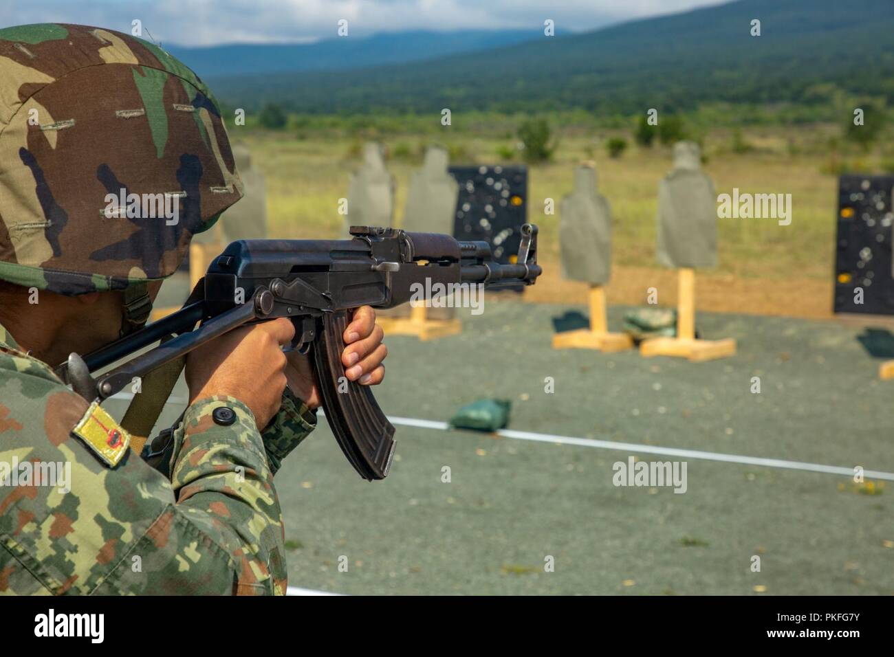 A member of the Albanian Armed Forces executes a Combat Marksmanship Program range during Exercise Platinum Lion 18 at Novo Selo Training Area, Bulgaria, Aug. 1, 2018. Platinum Lion is an annual field training exercise that reinforces relationships in a joint training environment, builds understanding of partner nation tactics, techniques and procedures, and increases interoperability with Allied and partner forces. Stock Photo