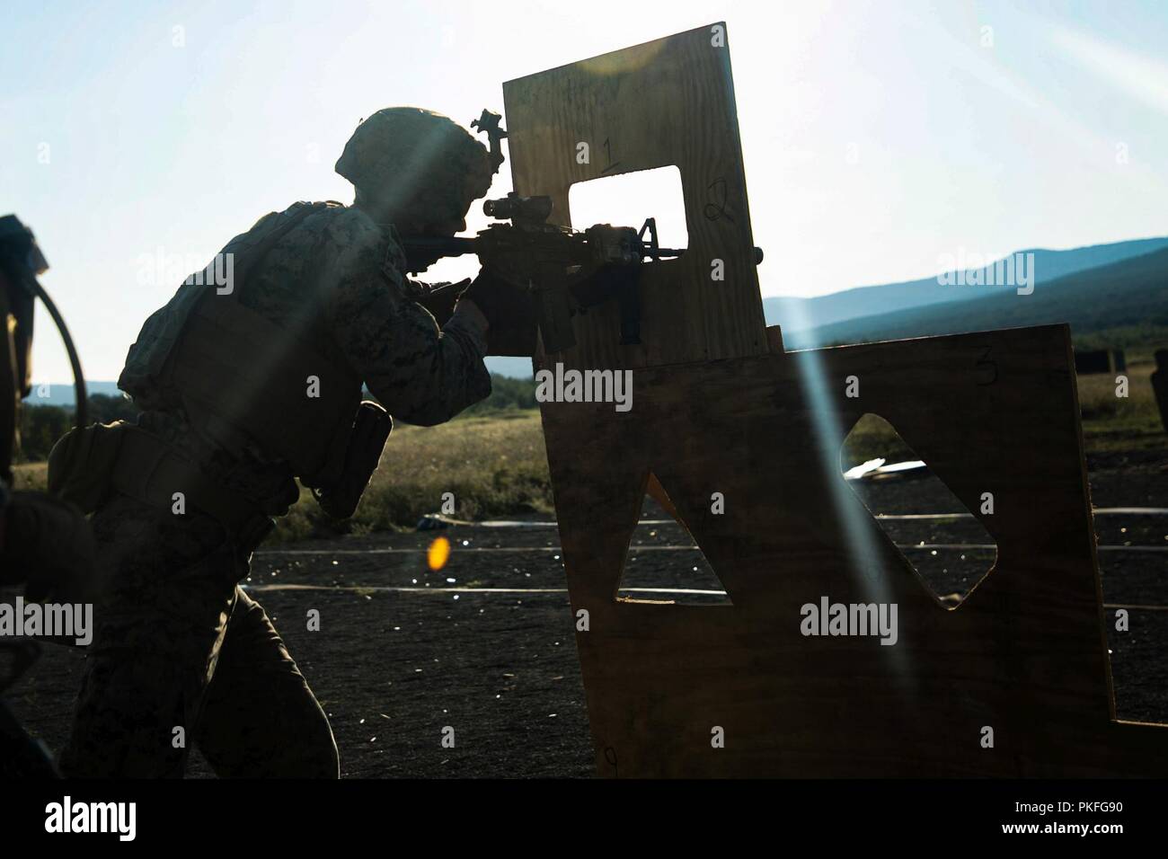 A U.S. Marine with Black Sea Rotational Force 18.1 execute an advanced portion of a Combat Marksmanship Program range during Exercise Platinum Lion 18 at Novo Selo Training Area, Bulgaria, Aug. 5, 2018. Platinum Lion is an annual field training exercise that reinforces relationships in a joint training environment, builds understanding of partner nation tactics, techniques and procedures, and increases interoperability with Allied and partner forces. Stock Photo