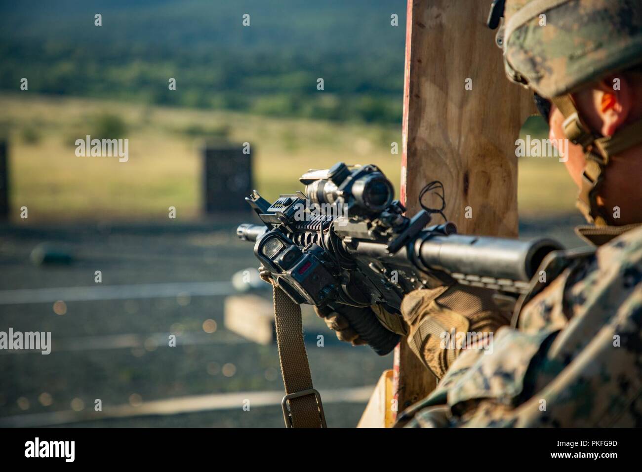 A U.S. Marine with Black Sea Rotational Force 18.1 conducts a tactical reload while executing an advanced portion of a Combat Marksmanship Program range during Exercise Platinum Lion 18 at Novo Selo Training Area, Bulgaria, Aug. 5, 2018. Platinum Lion is an annual field training exercise that reinforces relationships in a joint training environment, builds understanding of partner nation tactics, techniques and procedures, and increases interoperability with Allied and partner forces. Stock Photo