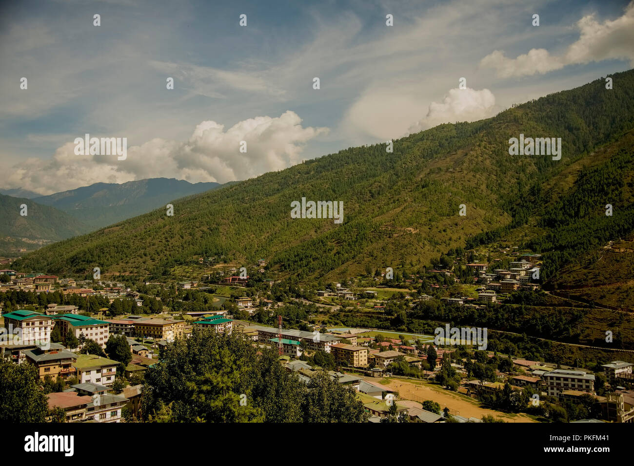 Western panorama,sloping hill,forest,surronding Thimpu,quiet flows, river,bank,township,Thimpu chu,Bhutan. Stock Photo