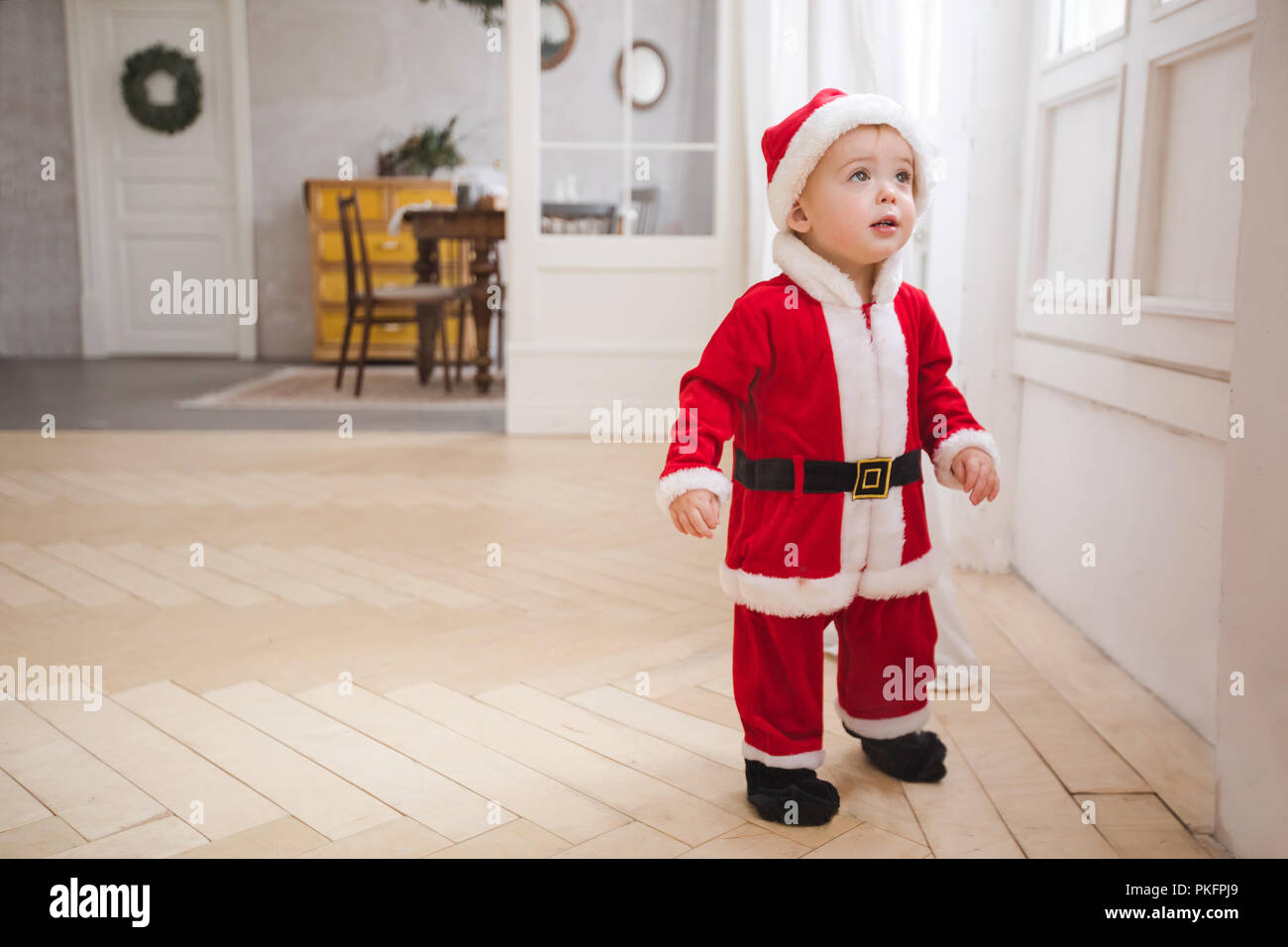 Little boy in Christmas costume standing in room Stock Photo