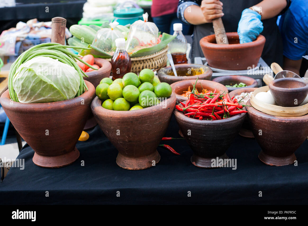 clay bowls with fresh vegetables cabbage lime and red chili peppers