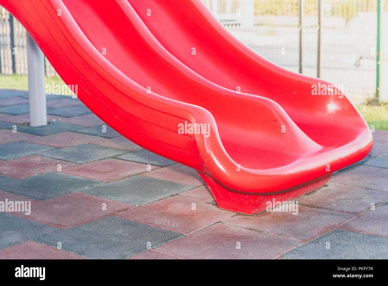 Side view of red plastic slide for children at the children park in daytime  Stock Photo - Alamy