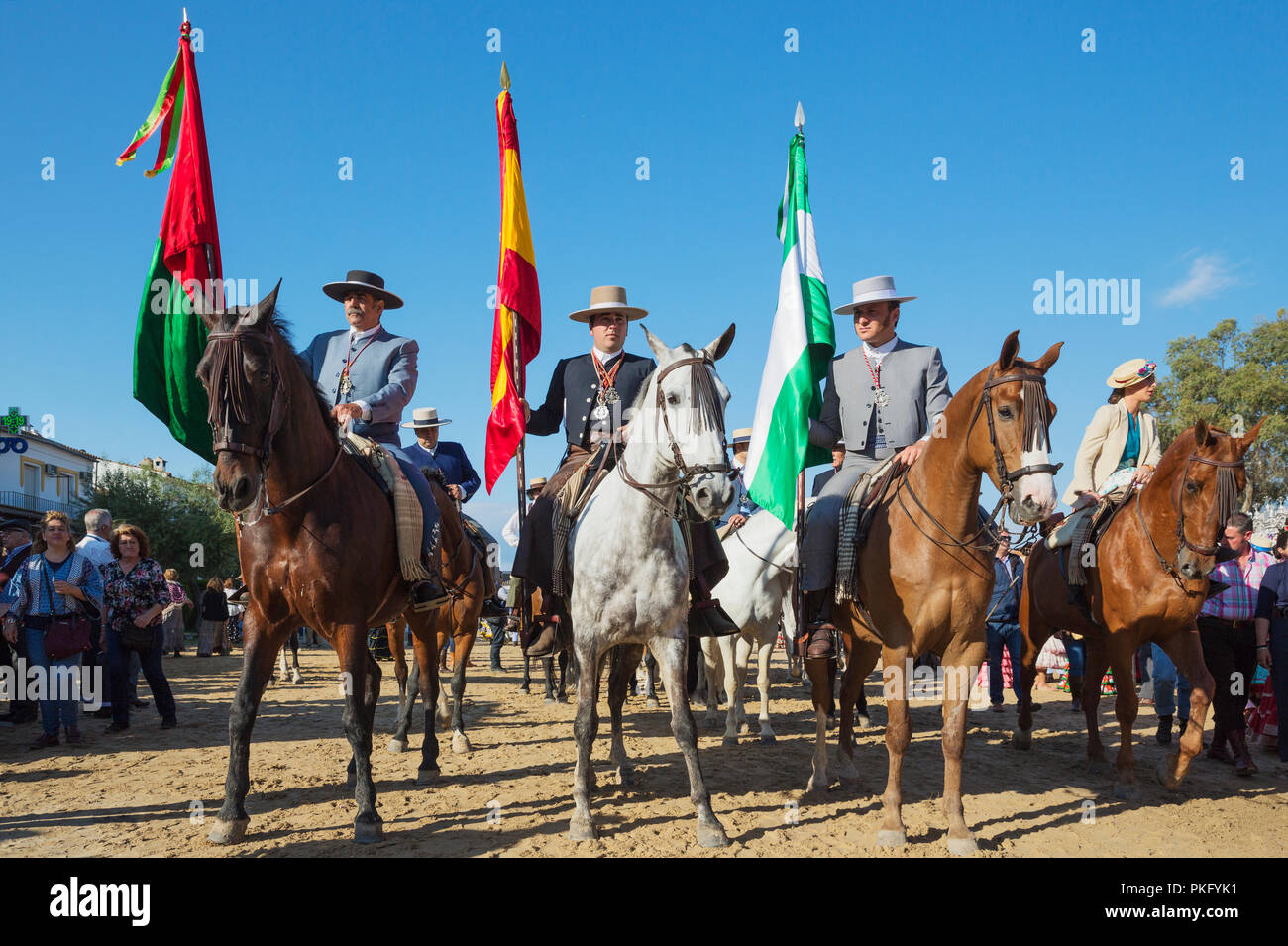 People in traditional clothes riding horses, Pentecost pilgrimage of El Rocio, Huelva province, Andalusia, Spain Stock Photo