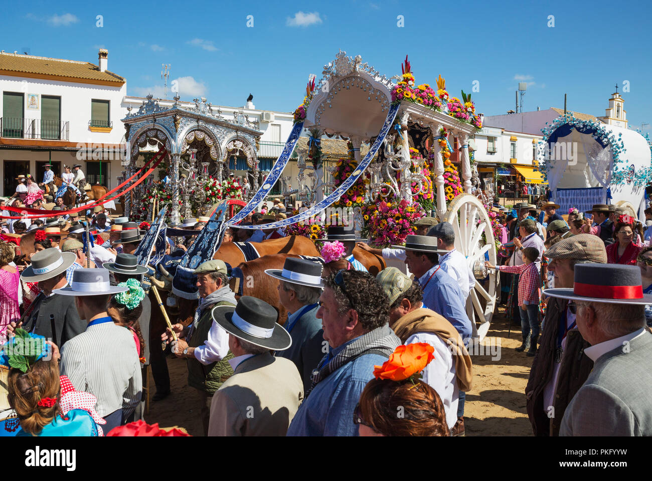 Decorated oxcarts, people in traditional clothes, Pentecost pilgrimage of El Rocio, Huelva province, Andalusia, Spain Stock Photo