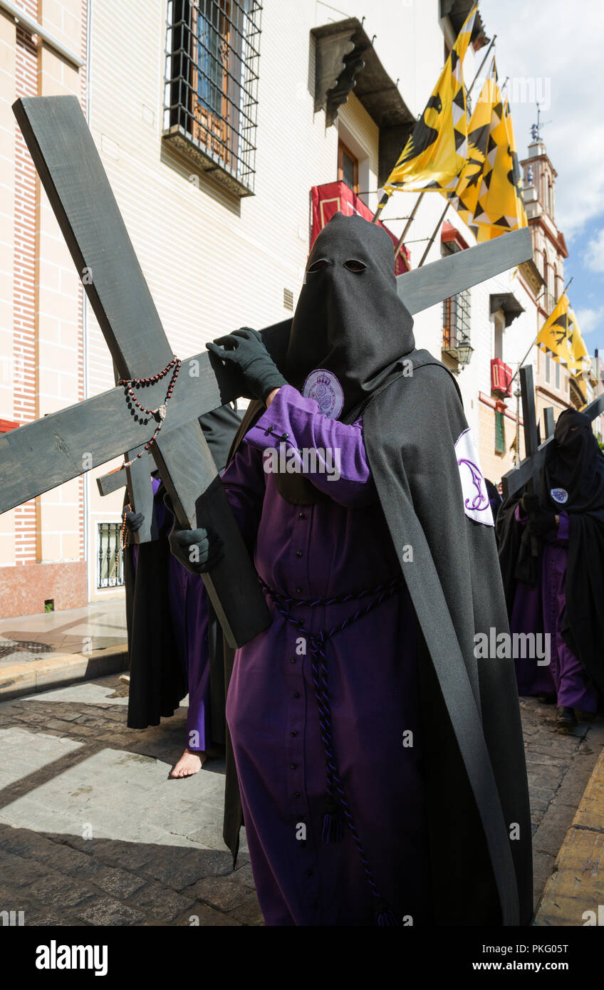 Penitent with cross and rosary at the Semana Santa, the Holy Week, Seville, Andalusa, Spain Stock Photo