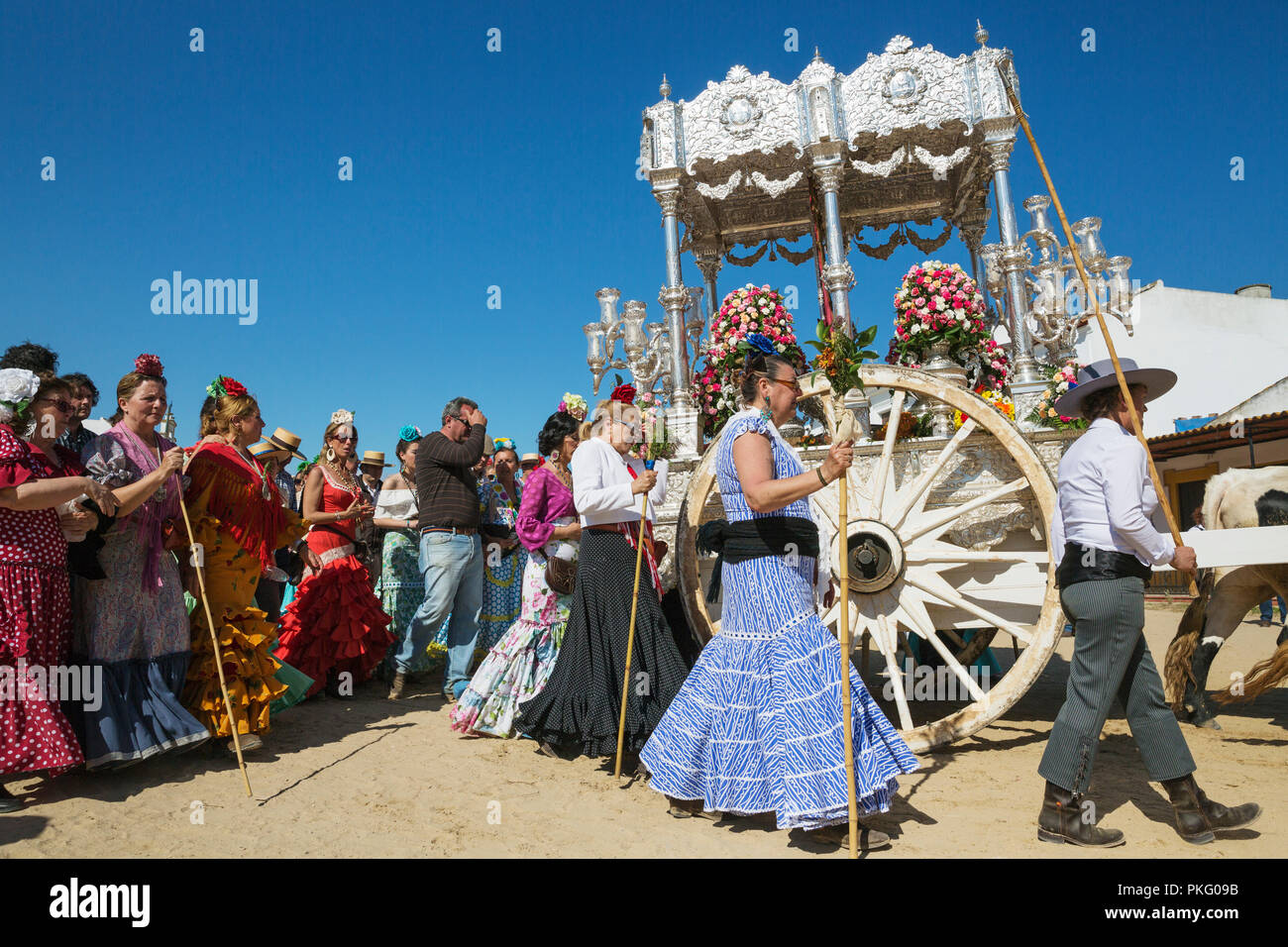 People in traditional clothes and decorated oxcarts, Pentecost pilgrimage of El Rocio, Huelva province, Andalusia, Spain Stock Photo