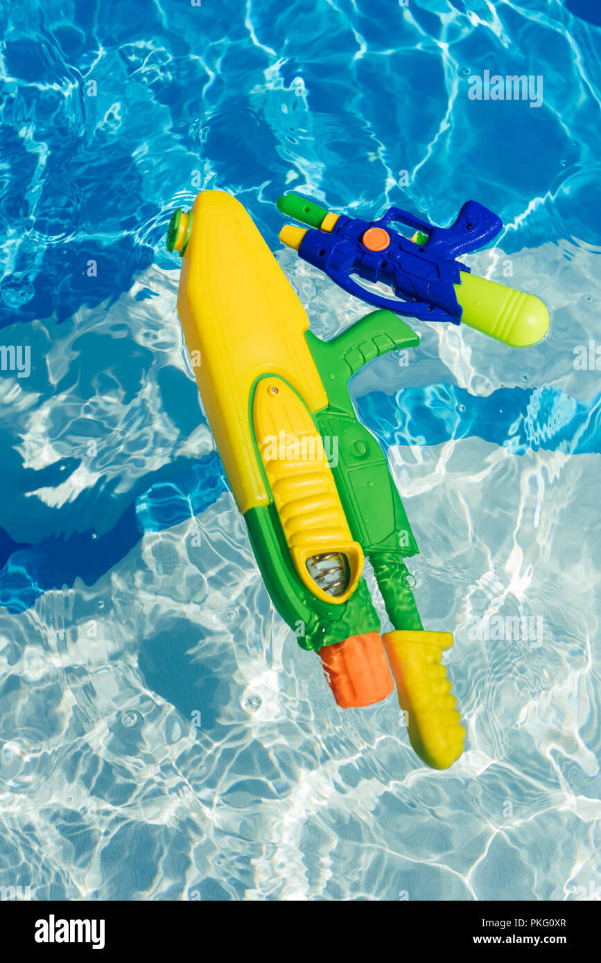 plastic colorful water guns floating in swimming pool Stock Photo Alamy