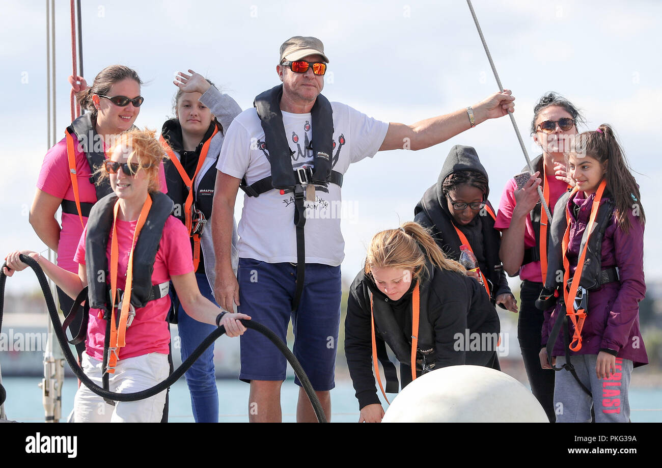 Simon Le Bon (centre) arrives back at Gunwharf Quays on board a 72 foot Challenger yacht with members of the Tall Ships Youth Trust team, after racing in the Solent. Stock Photo