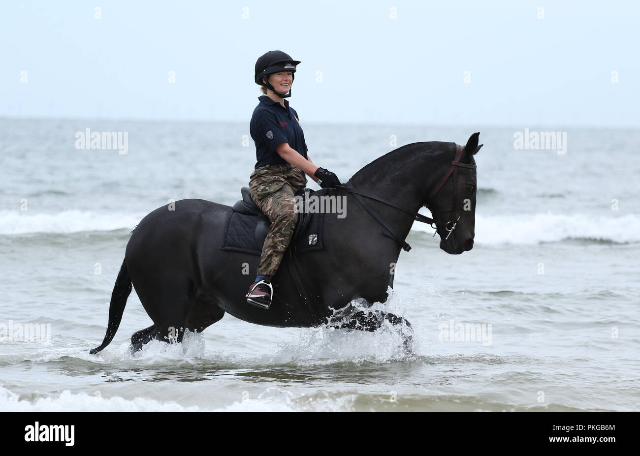 Holkham, Norfolk, UK. 12th Sep 2018. A soldier and her horse from The Kings Troop Royal Horse Artillery enjoying their training on the beach at Holkham, Norfolk, on September 12, 2018. Credit: Paul Marriott/Alamy Live News Stock Photo