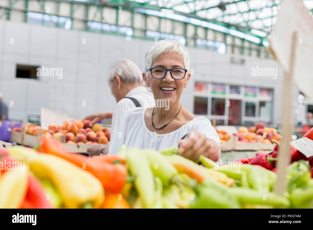 Portrait of senior woman buying on market Stock Photo