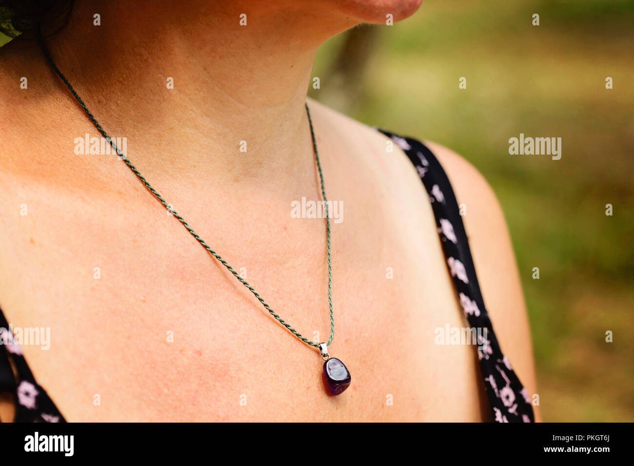 Woman wearing a Amethyst pendant necklace Stock Photo