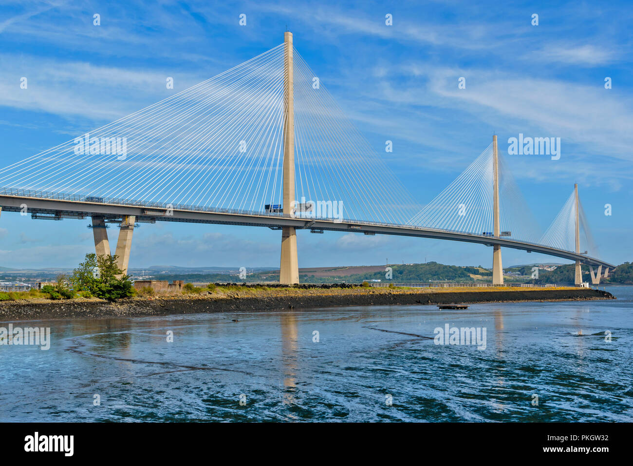 QUEENSFERRY CROSSING FIRTH OF FORTH SCOTLAND BRIDGE AT LOW TIDE AND EARLY MORNING SUNSHINE ON THE CABLES Stock Photo