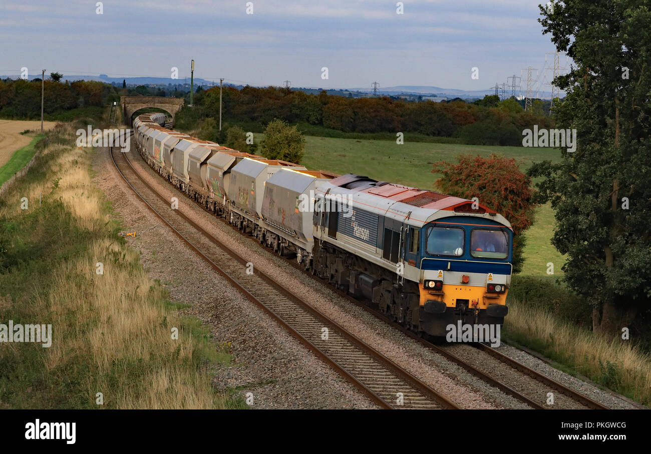 Mendip Rail diesel locomotive no 59004 passes Berkley near Westbury in Somerset with an empty stone train returning from Acton to Whatley Quarry. Stock Photo