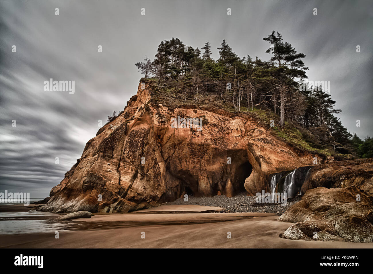 Hug Point State Park, Oregon and waterfall coming off the ledge Stock Photo