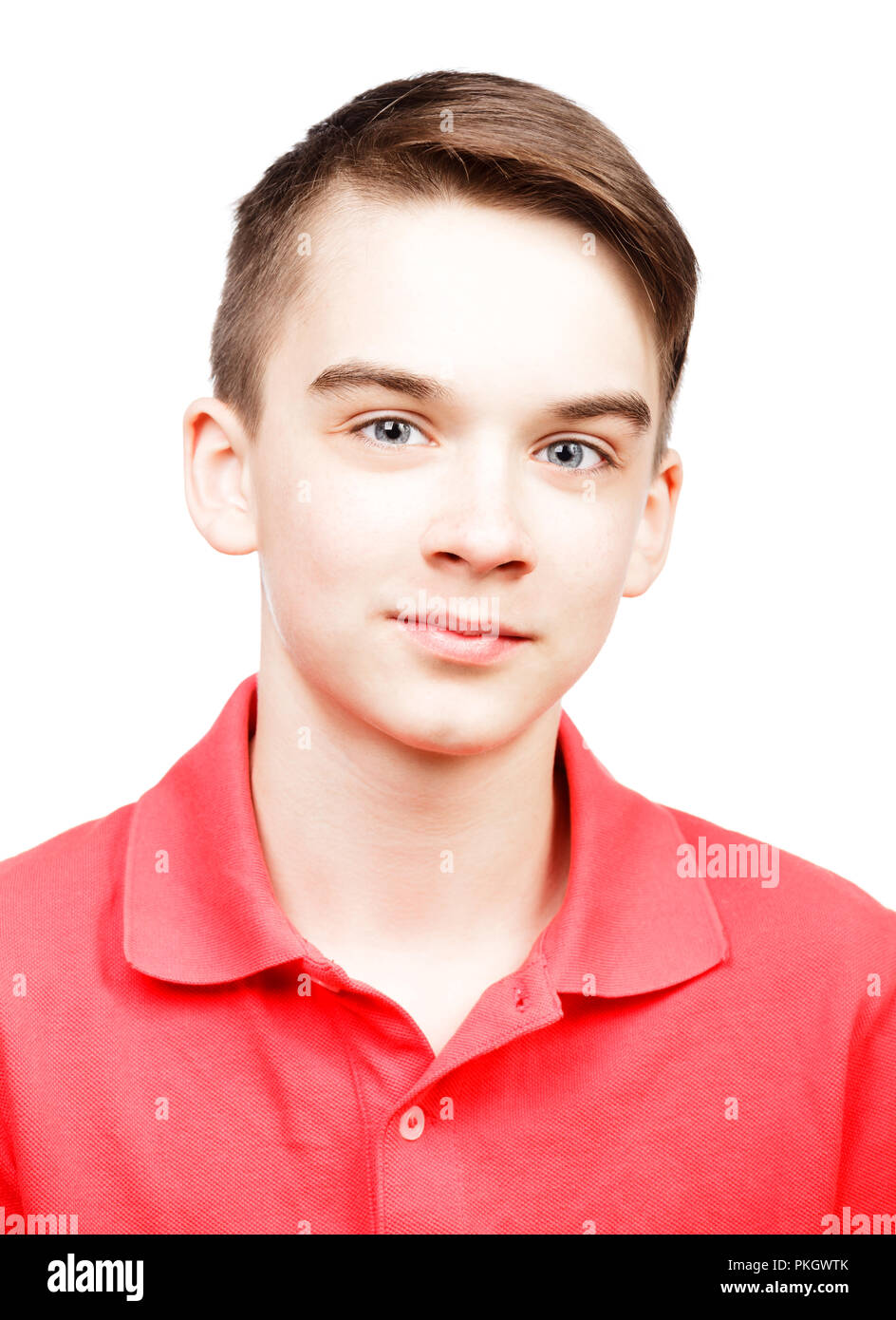 Portrait of cheerful teenager boy wearing red polo shirt isolated on white background Stock Photo