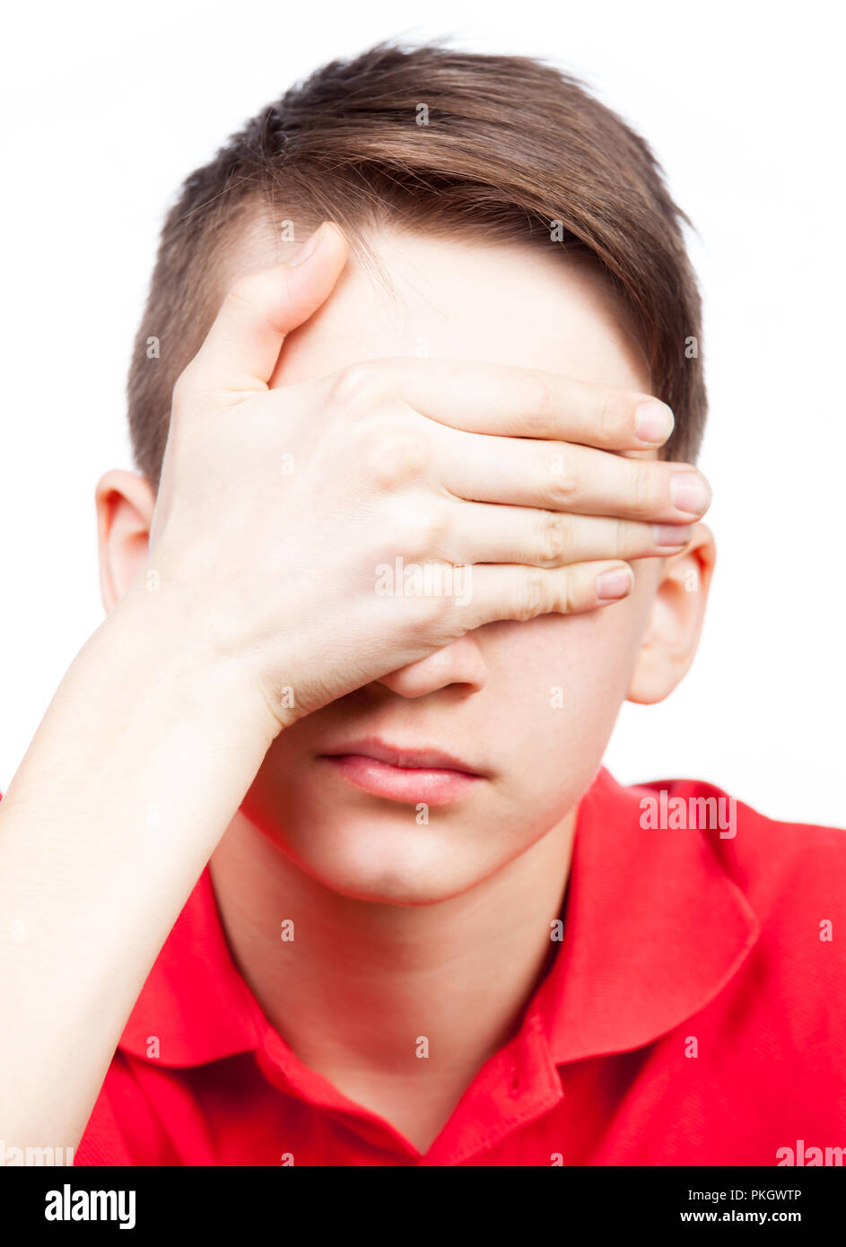 Portrait of teenager boy cover his eyes with hand isolated on white ...