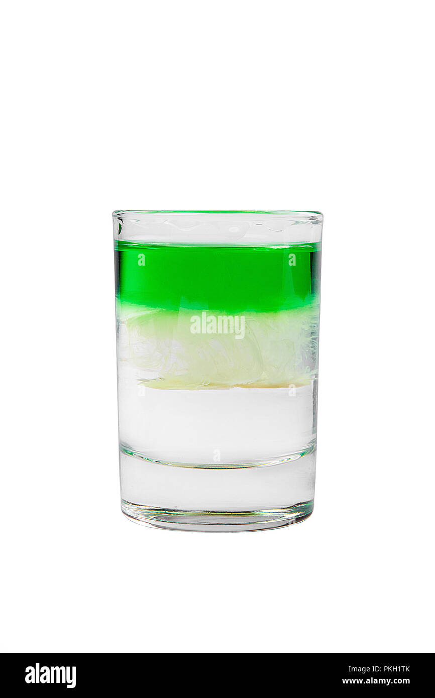 Multicolored layered cocktail, glass with transparent and colored drink