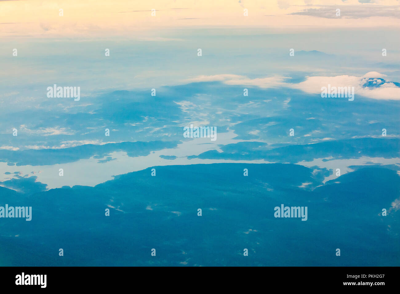 Aerial birds eye view above clouds of the blue sky Stock Photo - Alamy