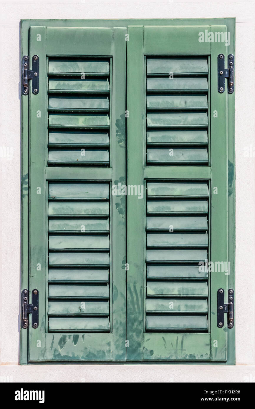 Green, wooden, louvred shutters, closed Stock Photo