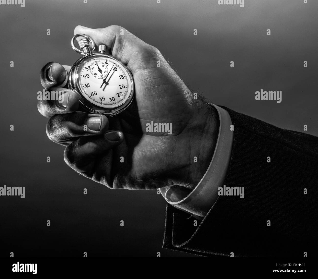 A business hand holding stop watch in black white Stock Photo Alamy