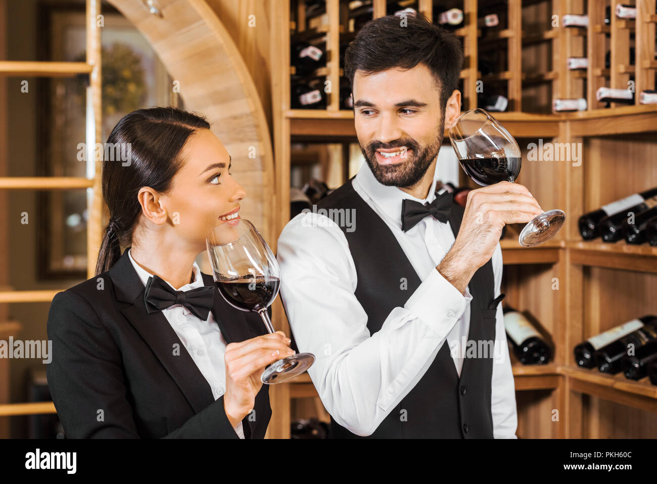 couple of happy wine stewards making degustation together and chatting