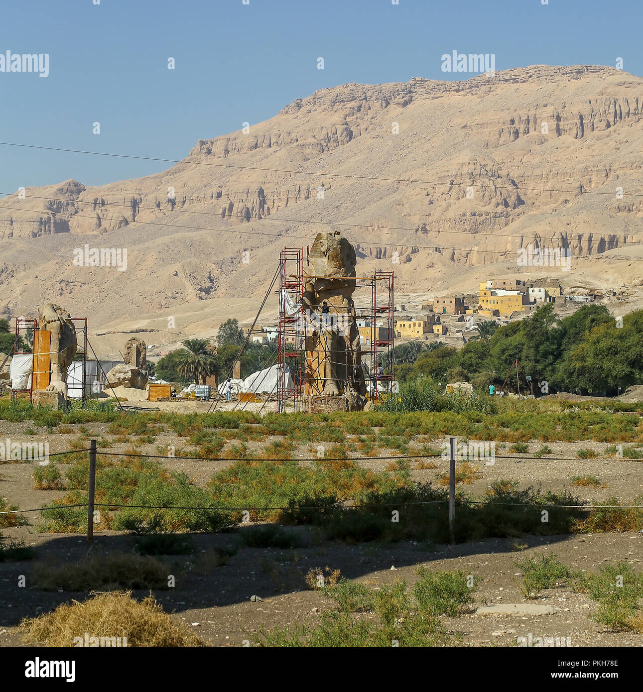 The Colossi of Memnon, two massive stone statues of the Pharaoh Amenhotep III, at the Theban Necropolis at Luxor, Egypt, Africa Stock Photo