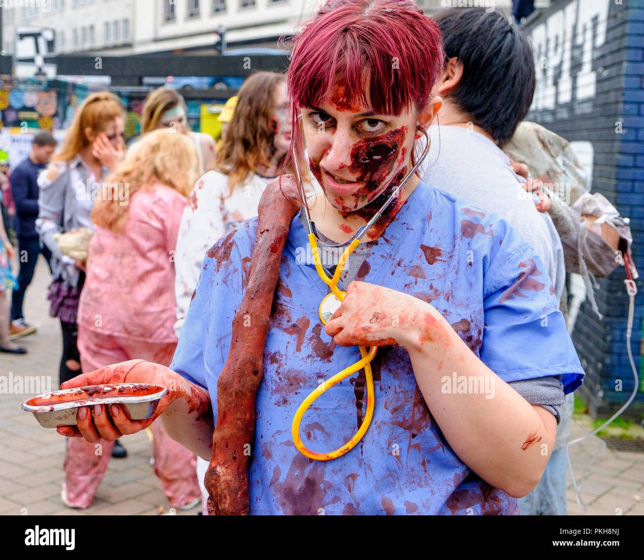 Bristol, UK. 28th Oct, 2017. A  woman dressed as a zombie nurse doctor is pictured as she takes part in a zombie walk through the city centre. Stock Photo