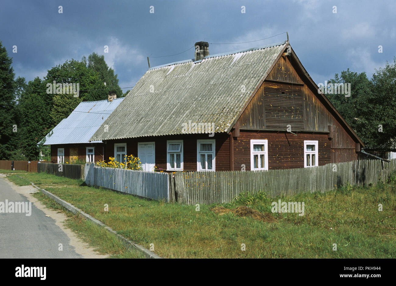 Typical wooden clad cottage in a village in the Augustowska forest in the Suwalszczyzna region of north east Poland August 2007 Stock Photo