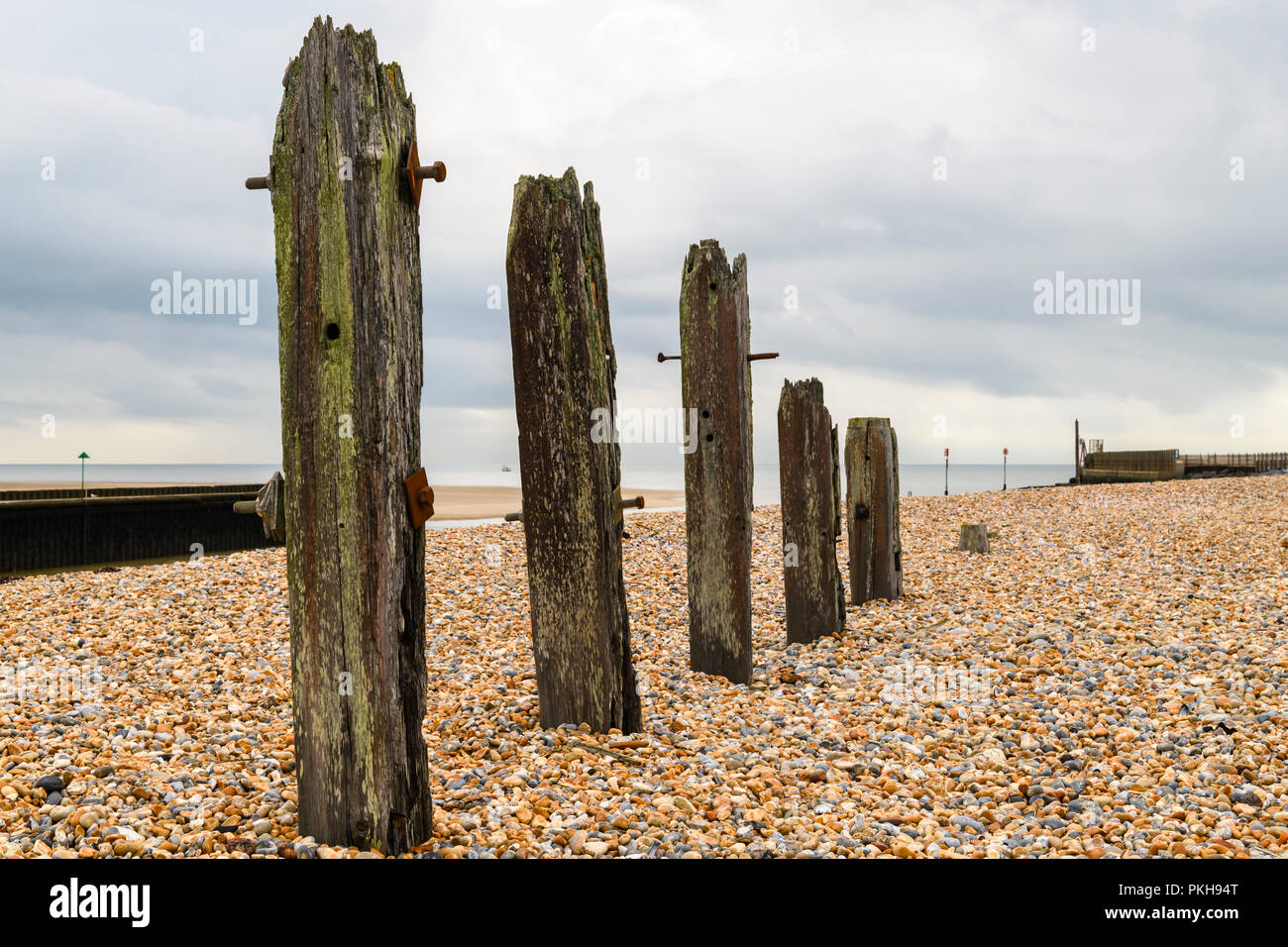 Some of the old sea defences in the shingle at the entrance to Rye harbour, East Sussex, England. 30 August 2018 Stock Photo