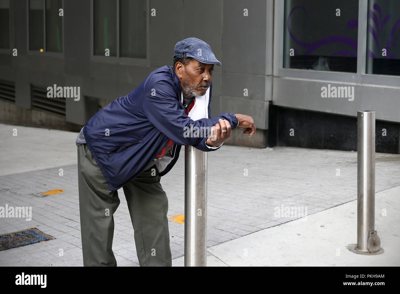 Unidentified man standing in the street in Boston, MA Stock Photo