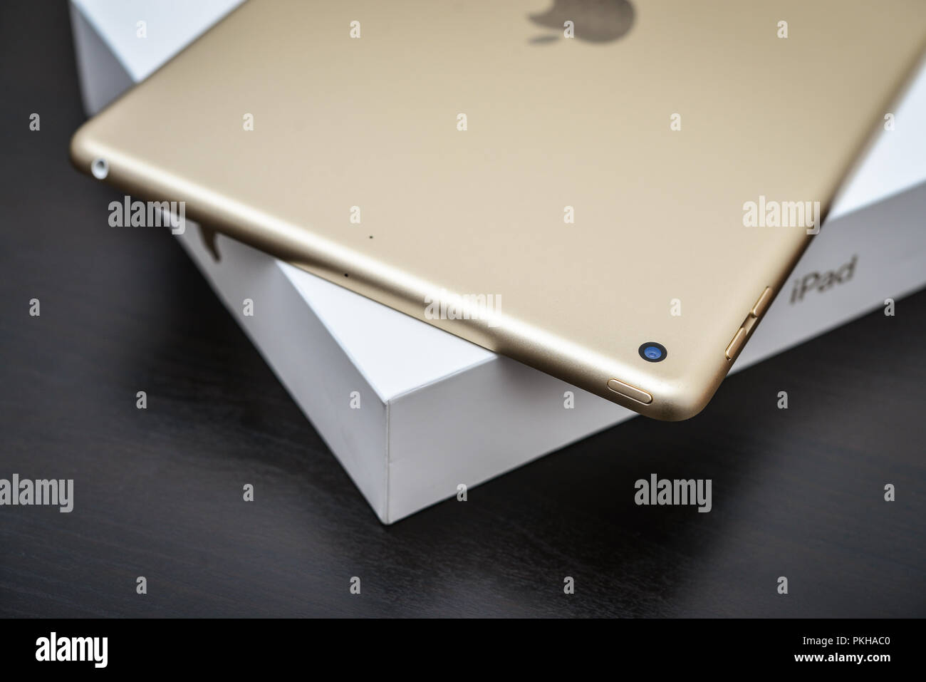 Kyiv, Ukraine - Fabruary 6, 2018: Brand new white Apple iPad Gold with box on black wooden background closeup, 7th generation of the iPad, developed b Stock Photo