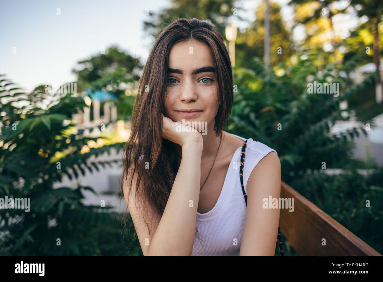 Close Up Candid Portrait Of Beautiful Happy Young Woman Brunette With Long Hair Sitting On Bench In Green Park Pleasant Teen Female Smiling And Frien Stock Photo Alamy