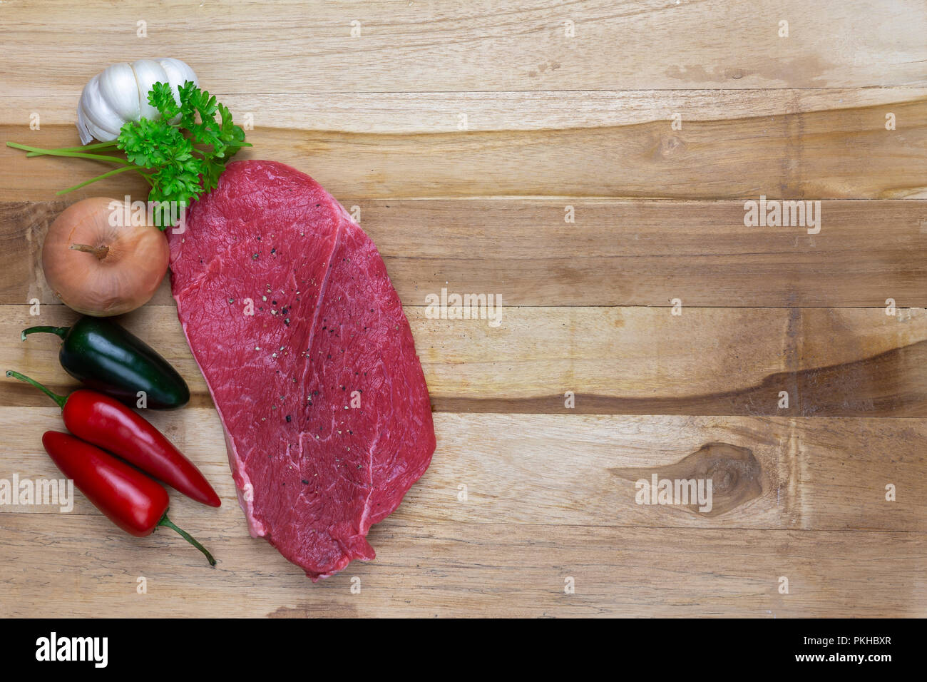 red meat on a wooden platter Stock Photo