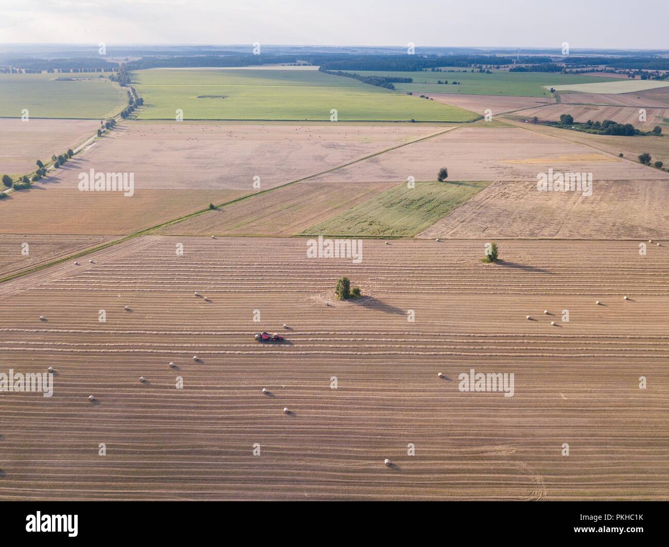 Aerial: stubble field with straw bales at late summer. Polish landscape ...