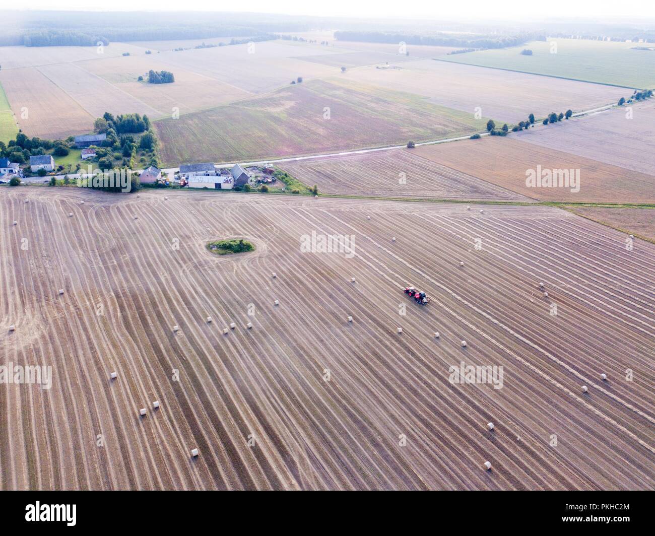 Aerial: stubble field with straw bales at late summer. Polish landscape ...