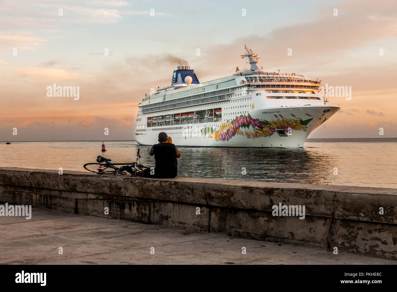 Havana, Cuba. 04th July 2017 A man takes a photograph of the cruise liner Norwegian Sky arriving into the Port of Havana Cuba. -Credit David Creedon / Stock Photo